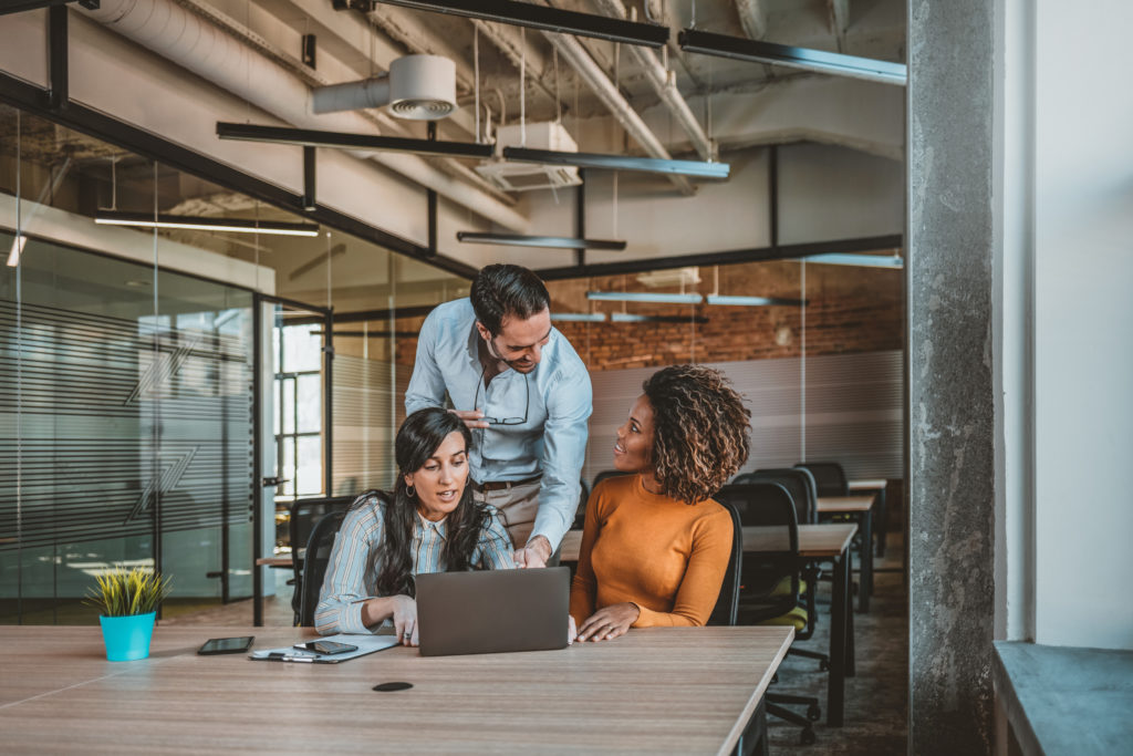 Business professionals. Group of young confident business people analyzing data using computer while spending time in the office