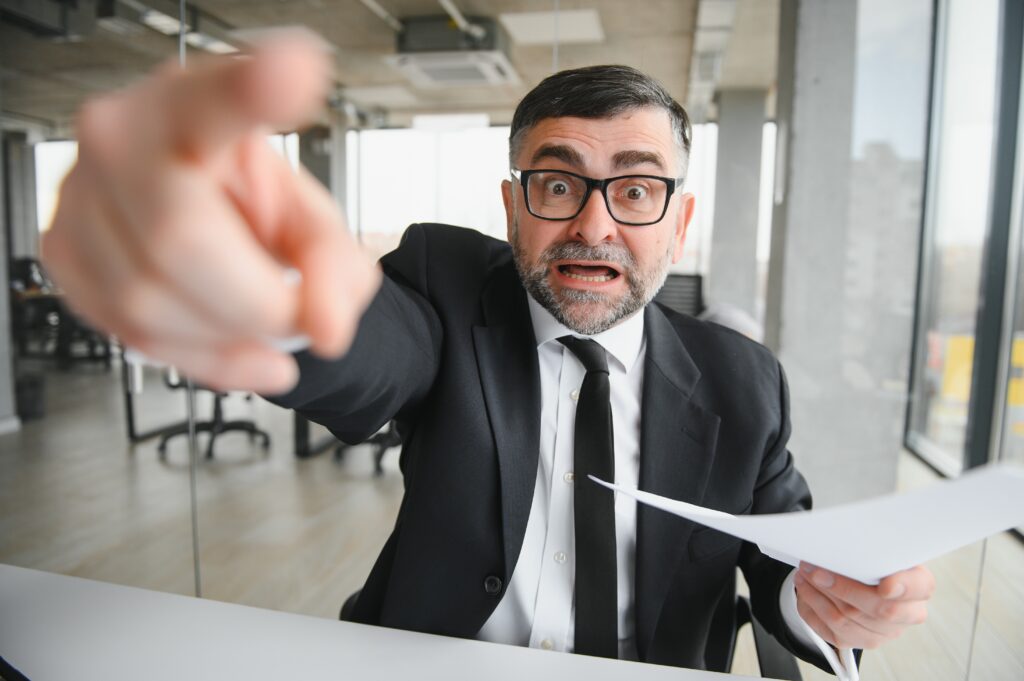 Stereotypical HR manager shouting at an employee and an example of the need for transforming HR