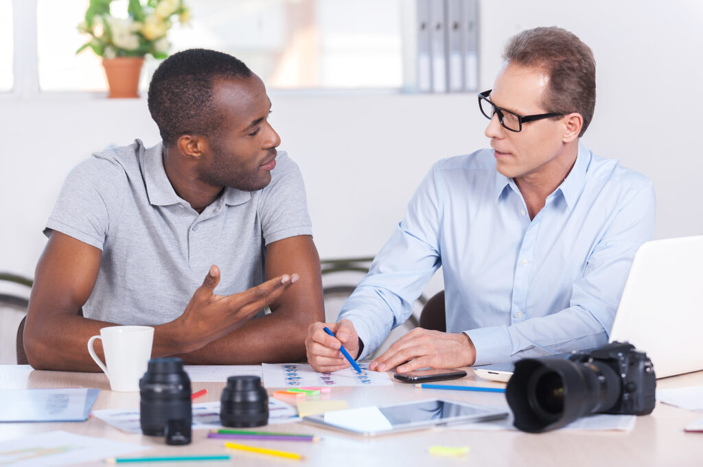 Two men discussing what should a good human resources organization cover?